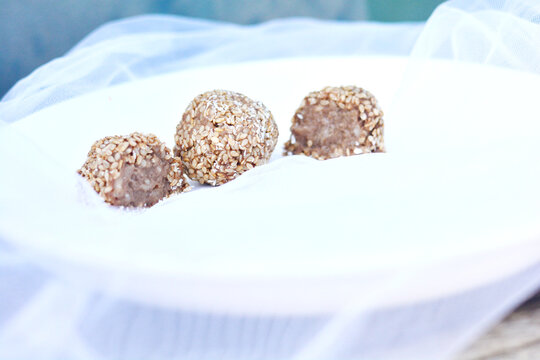 Delicious sesame chocolate balls. Soft fabric background.