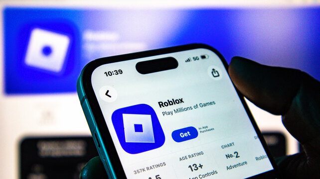 Closeup of a smartphone screen displaying the roblox app store page with the get button visible