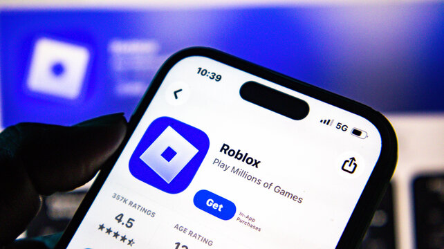 Closeup of a smartphone screen displaying the roblox app store page with the get button visible