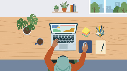 Obraz premium Overhead view of a person working on a laptop at a desk with office supplies.