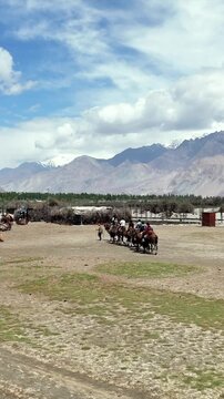 Vertical Aerial View of Tourists Enjoying Camel Ride in Nubra Valley Ladakh India