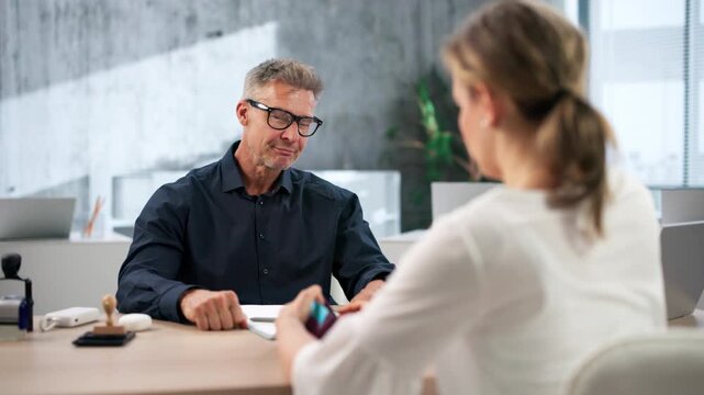 Bail Bondsman Helps Worried Female Client Sign Legal Release Contract