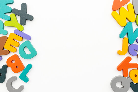 Flat Lay Studio Shot of Colorful Wooden Alphabet Side Borders with Central Copyspace