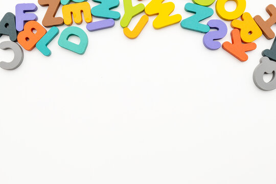 Flat Lay Studio Shot of Colorful Wooden Alphabet Border with Copyspace
