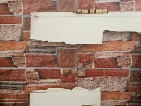 Severely Damaged Plastic Door Panel with Rusty Hinge