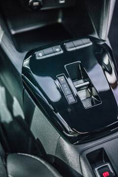 Modern car interior with automatic gear shifter and electronic parking brake