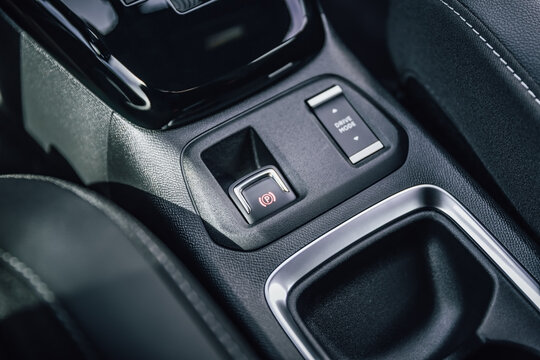 Modern car interior with automatic gear shifter and electronic parking brake