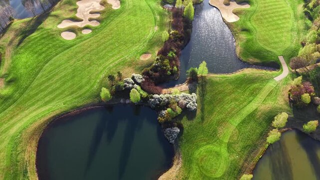 Aerial landscape of golf course with water and trees