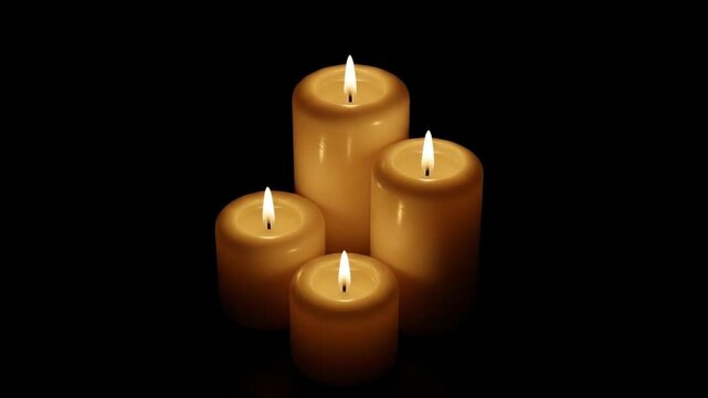 A serene arrangement of four illuminated pillar candles in the dark