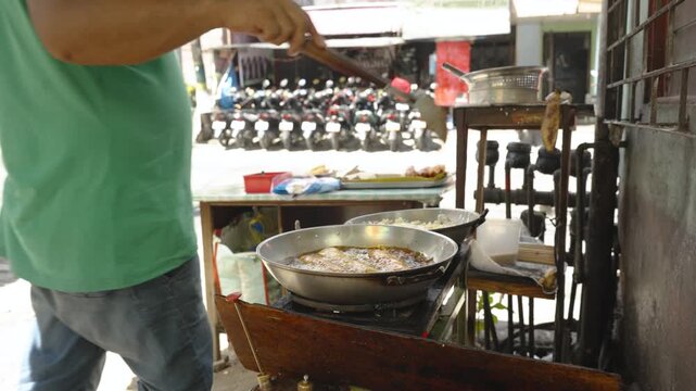 Filipino Vendor Cooking Banana Spring Rolls and Adding Brown Sugar at Street Market