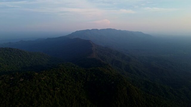Wide Aerial View of Tropical Rainforest Valley in Ecuador at Dusk, Layered Mountain Ridges, Dense Green Forest and Remote Andean Amazon Wilderness