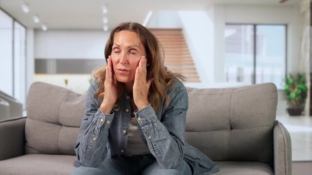 Older Woman Sitting Quietly At Home, Feeling Dizzy