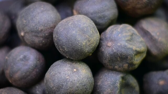 Macro close-up pile of small dried limes citrus fruits heap texture ingredient