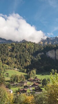 Lauterbrunnen Switzerland time lapse at village valley in autumn season and Mannlichen peak (vertical)
