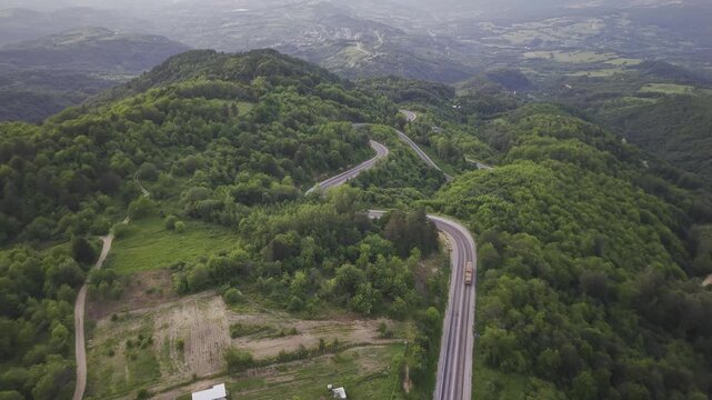 Aerial view of winding asphalt mountain road among green trees in summer. (Domani&ccedil;,İneg&ouml;l dağ yolu)