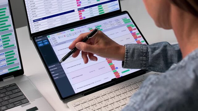 Medical Billing Coder Carefully Reviews Spreadsheet Data