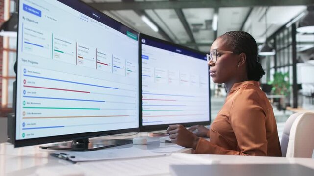 Young African American Woman Carefully Tracks OKR Progress