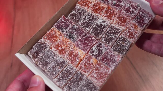 Oriental sweets in coconut chips and powdered sugar - Turkish delight. Turkish sweets are similar to jelly made from natural juice.