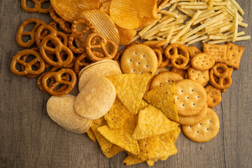 Obraz premium Mix of variety snack chips pretzel and cracker, junk crunchy food.