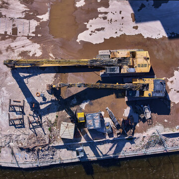 Wormerveer, Netherlands - 28 April 2026: Aerial view of heavy hydraulic demolition machinery on the site of the former Meneba flour mill during the Zaankwartier redevelopment.