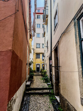 Colourful facades in a narrow alley in the old town of Lisbon, Portugal.