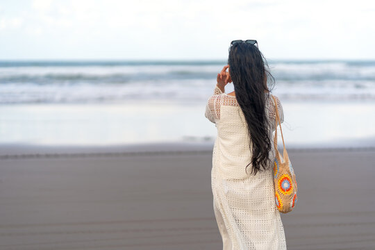 Back View of Asian Woman Looking at Ocean on Parangtritis Beach