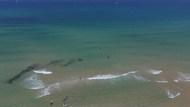 4K Static Drone Shot of Turquoise Mediterranean Sea with Swimmers, HaKeshet Beach, Ashdod, Israel, Slow Motion
