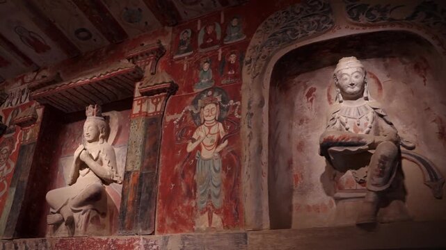 The mural art of the Mogao Grottoes in Dunhuang, China: Ancient Eastern art. Ancient Chinese murals, Mogao Grottoes in Dunhuang, Gansu Province, Buddhist statues, painted sculptures, and mural art.