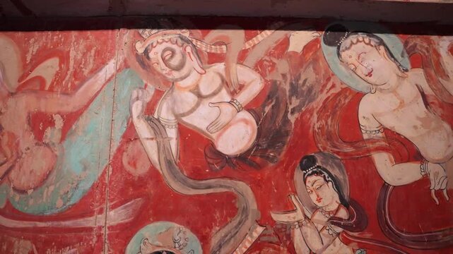 The mural art of the Mogao Grottoes in Dunhuang, China: Ancient Eastern art. Ancient Chinese murals, Mogao Grottoes in Dunhuang, Gansu Province, Buddhist statues, painted sculptures, and mural art.