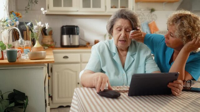 Caregiver comforts a senior woman with a warm hug after a family video call, offering emotional support, compassion and quality home care.
