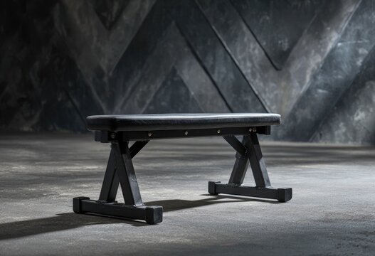 Black weight bench in dark gym