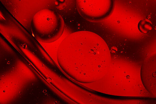 Red oil and water bubbles abstract fluid art composition