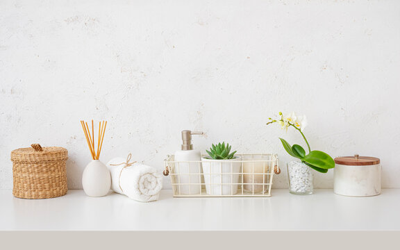 Spa and bath products composition with orchid flower on white table and abstract texture wall as background