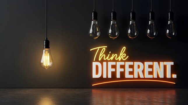 Creative inspiration concept with single glowing lightbulb and neon text think different on dark wall