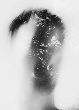 Conceptual monochrome double exposure portrait of human silhouette mixed with foliage texture inspiring psychological identity and memory layouts