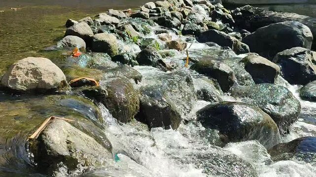 River Rapids Over Rocks with Plastic Waste Pollution in Indonesian Waterway