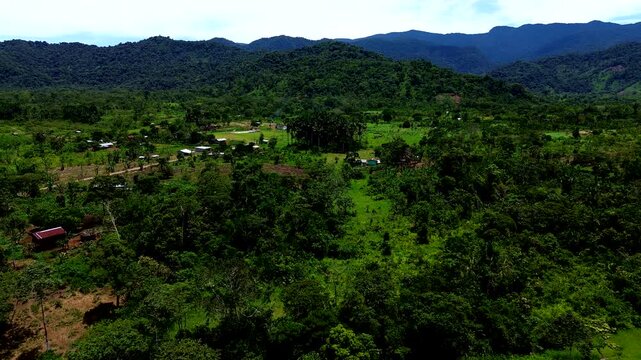 Wide Aerial View of Tropical Ecuador Valley with Forest, Farmland, River Corridor, Green Mountains and Remote Andean Amazon Rural Landscape