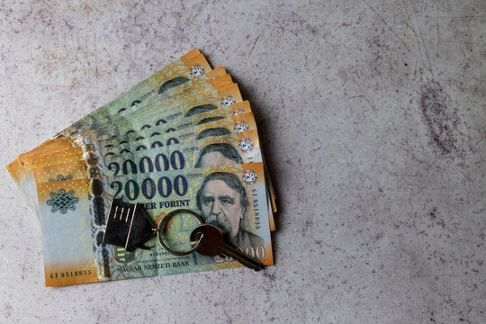 Hungarian Forint Banknotes with House Key Representing Property Purchase