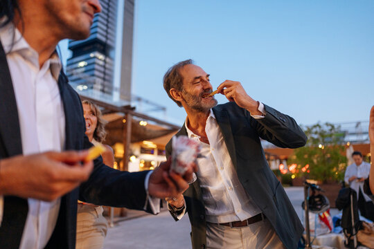 People sharing snacks at outdoor social gathering