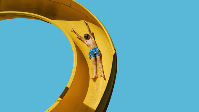 Off on vacation. A child is sliding down the water slide, is ready for her holiday. Dreaming of a vacation concept.