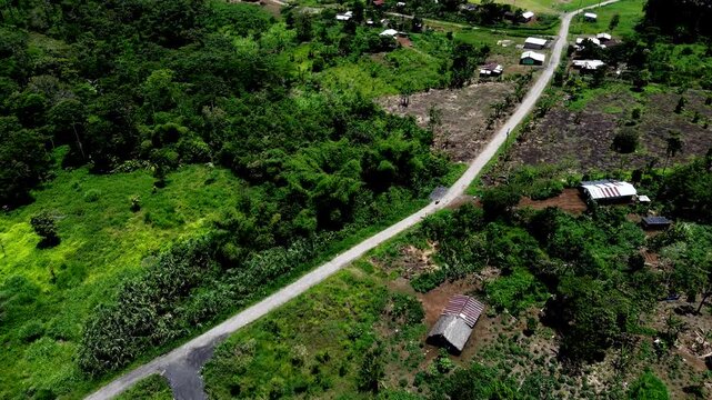 Aerial View of Rural Road and Small Farms in Tropical Ecuador, Forest Fragments, Green Fields, Houses and Remote Andean Amazon Countryside Scene
