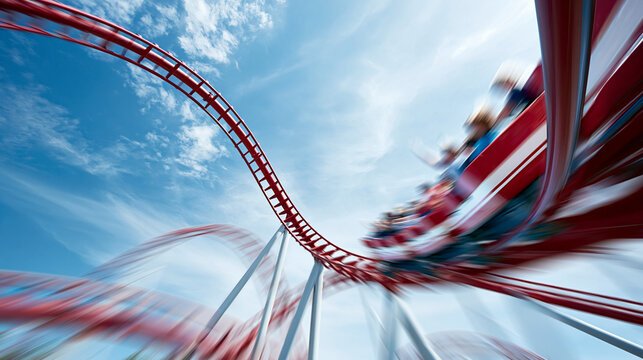 Roller coaster twisting through the air against a blue sky  