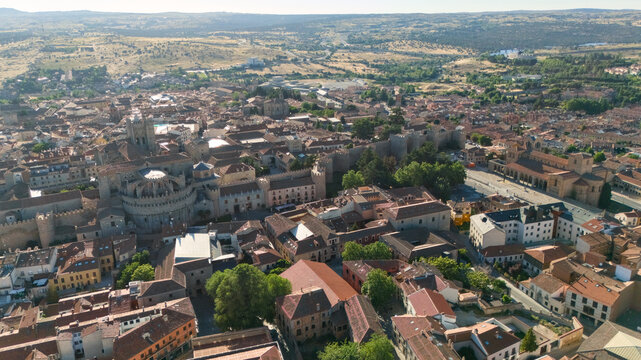 Aerial drone view of bullring arena surrounded by historic city rooftops and Castilian plains Avila