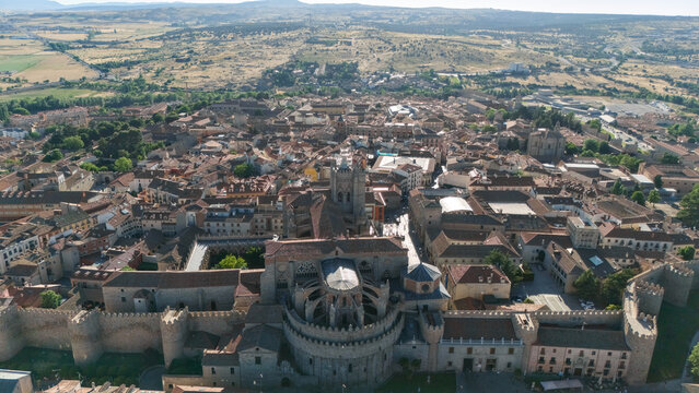 Drone aerial view of cathedral apse dome integrated into city walls with Avila urban panorama Spain