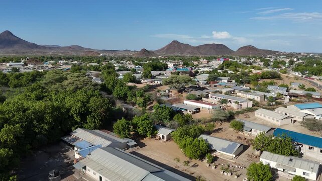 Aerial view of Lodwar, Turkana County, Kenya, showing green vegetation, low buildings, and rocky hills in the arid northern landscape.