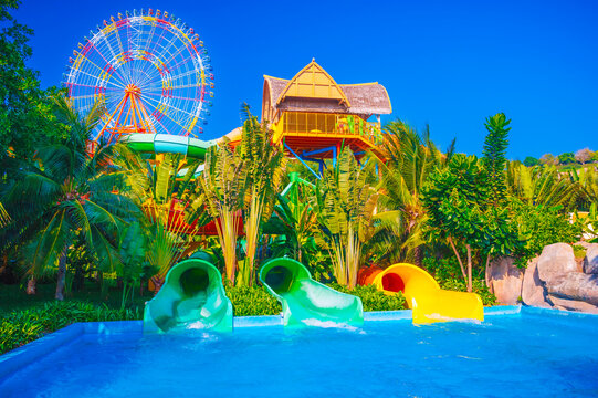 Colorful water park slides in a tropical resort paradise