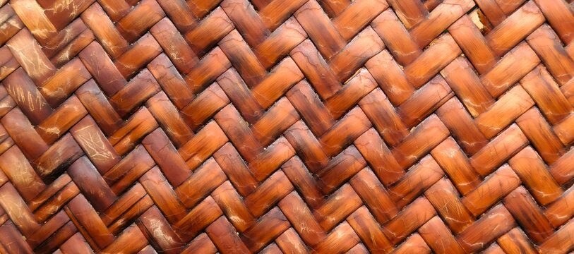 Close up of brown woven rattan bamboo texture background with herringbone pattern