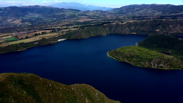 Aerial View of Andean Crater Lake in Ecuador with Deep Blue Water, Volcanic Slopes, Green Hills and Scenic Highland Nature Travel Landscape