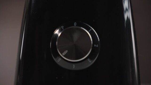 Hand Increasing Blender Speed From Level 3 to 5 Close-Up