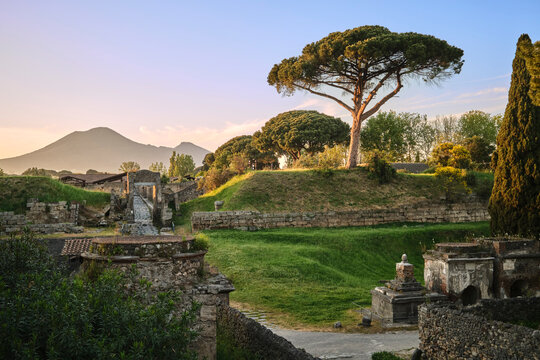 Historic ruins of the ancient city of Pompeii with Mount Vesuvius rising in the background. Pompei, Campania, Italy